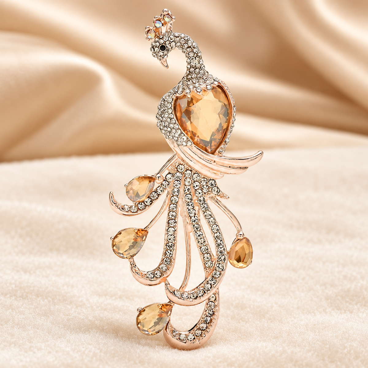 Jeweled Peacock with Flowing Loop Tail Brooch — styled background