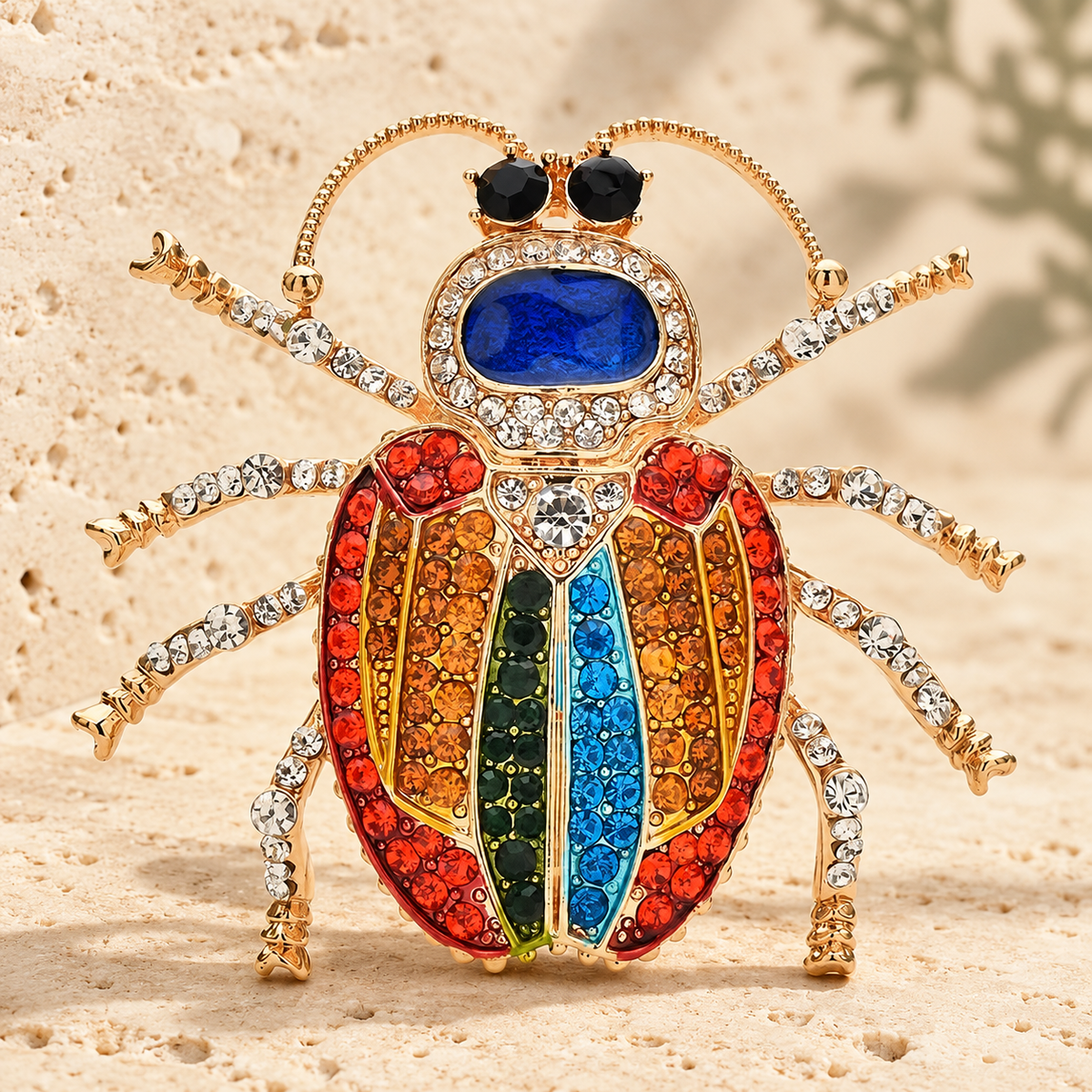 Multicolor Rhinestone Beetle Brooch — styled background