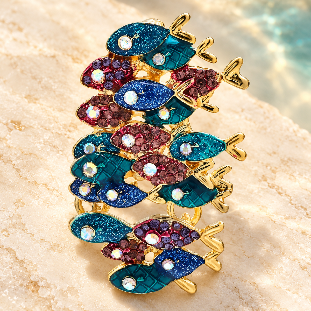 Blue and Purple Jeweled Fish School Brooch — styled background