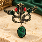 Ornate Snake with Green Oval Drop Brooch — styled background