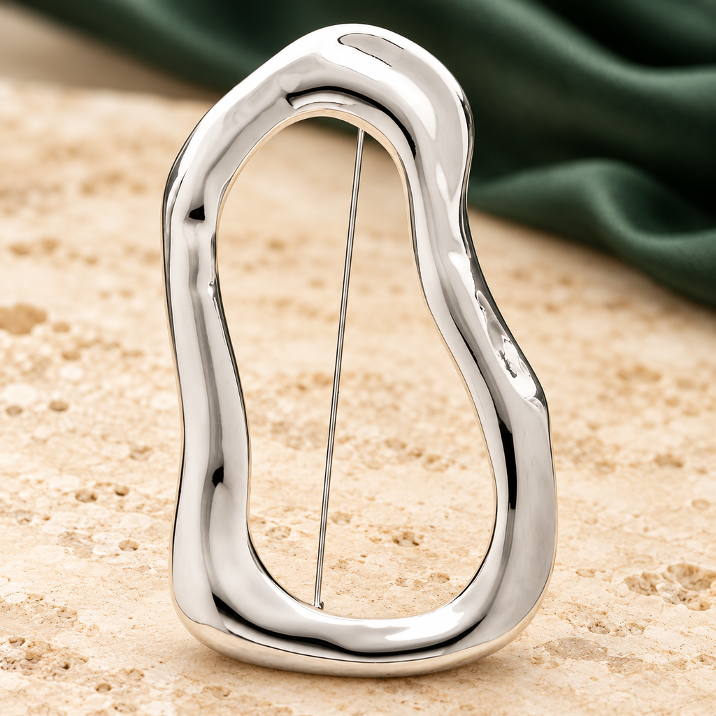 Polished Organic Openwork Loop Brooch — styled background