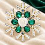 Jeweled Snowflake with White Rose Center Brooch — styled background