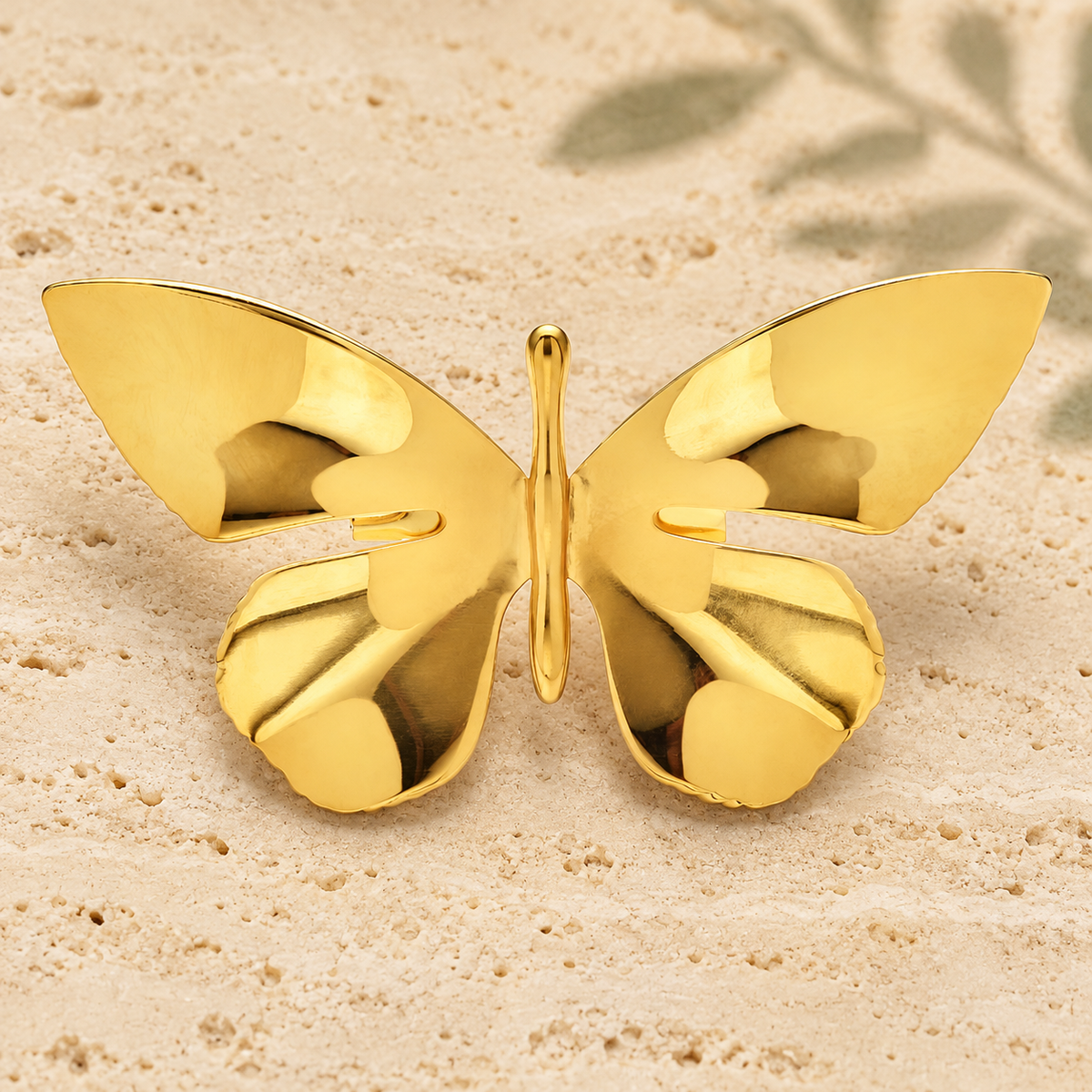 Polished Sculptural Butterfly Brooch — styled background