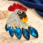 Rhinestone Rooster Head with Faceted Feathers Brooch — styled background