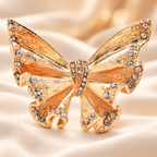 Pleated Butterfly with Rhinestone Edges Brooch — styled background