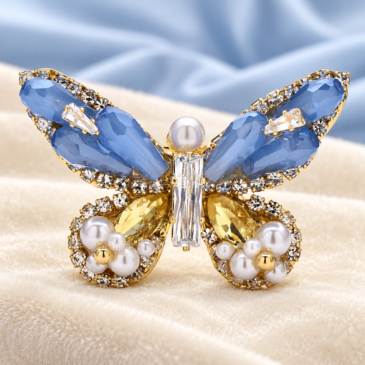 Faceted Butterfly with Pearl-Look Tips Brooch — styled background