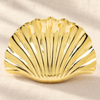 Polished Scallop Shell Brooch — styled background