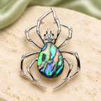 Iridescent Abalone-Look Spider Brooch — styled background