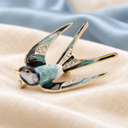 Patterned Enamel Flying Swallow Brooch — styled background