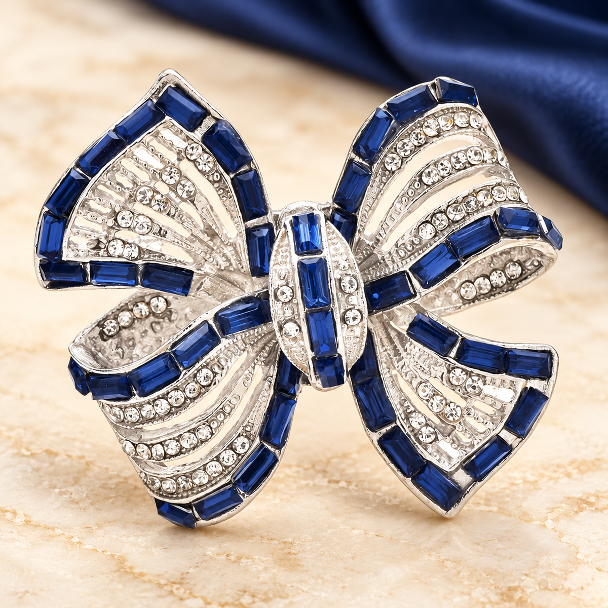 Blue and Clear Rhinestone Ribbon Bow Brooch — styled background