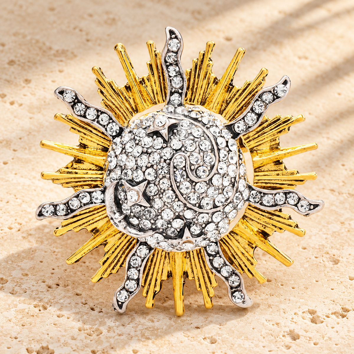 Radiant Sunburst with Rhinestone Center Brooch — styled background