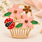 Enamel Flower Basket with Ladybug Brooch — styled background