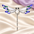 Iridescent Wing Dragonfly with Rhinestone Tail Brooch — styled background