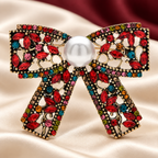 Vintage-Style Rhinestone Bow with Pearl-Look Center Brooch — styled background
