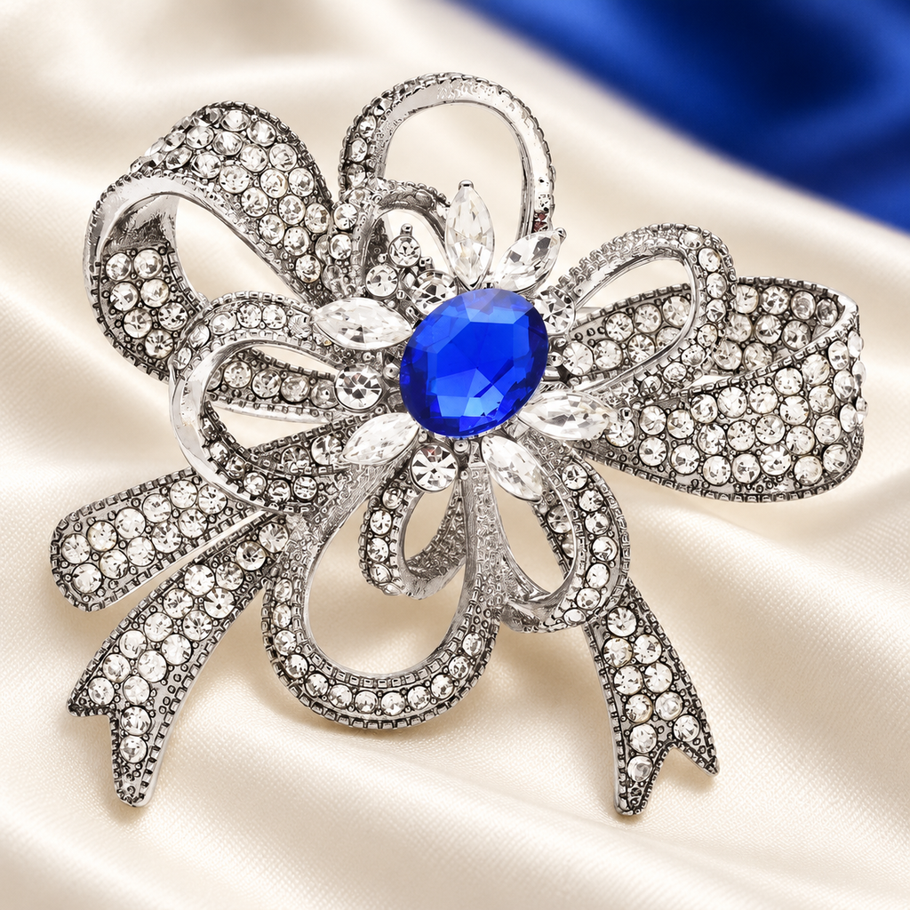 Rhinestone Flower Bow with Blue Center Brooch — styled background