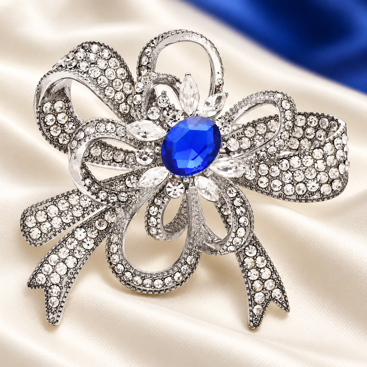 Rhinestone Flower Bow with Blue Center Brooch — styled background