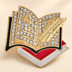 Rhinestone Open Book and Quill Brooch — styled background