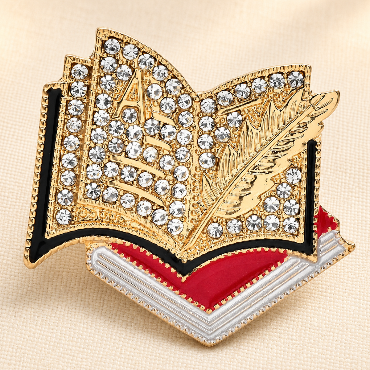 Rhinestone Open Book and Quill Brooch — styled background