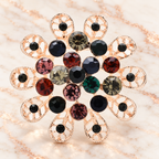 Round Rhinestone Flower with Looped Petals Brooch — styled background