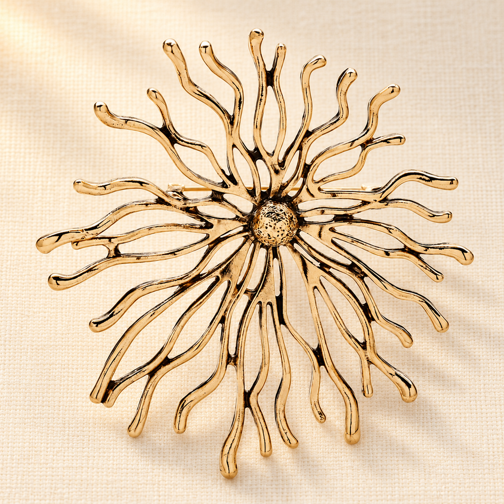 Sculptural Sunburst with Rhinestone Center Brooch — styled background