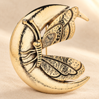 Crescent Moon and Butterfly Vintage-Style Brooch — styled background