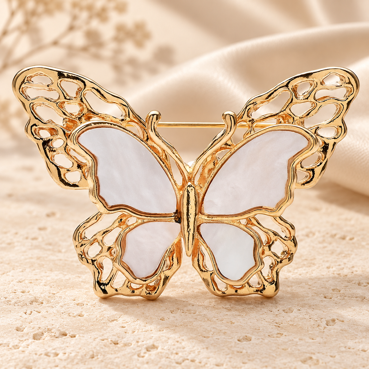 White Openwork Butterfly Brooch — styled background