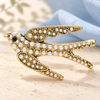 Pearl-Look Flying Swallow Brooch — styled background