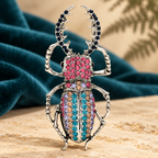 Large Jeweled Beetle Brooch — styled background