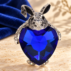 Rabbit Hugging Blue Heart Crystal Brooch — styled background