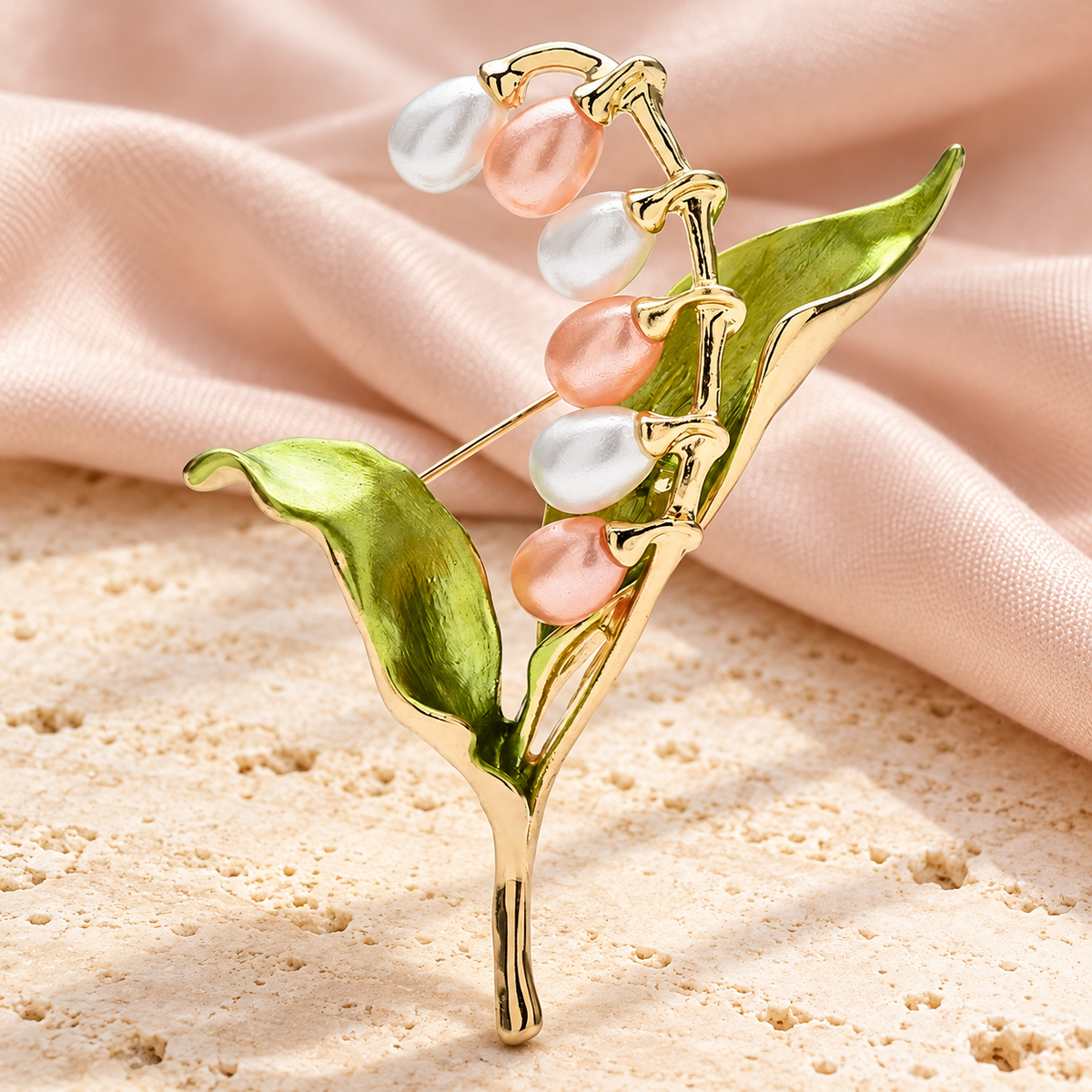 Pink Lily of the Valley with Green Leaves Brooch — styled background