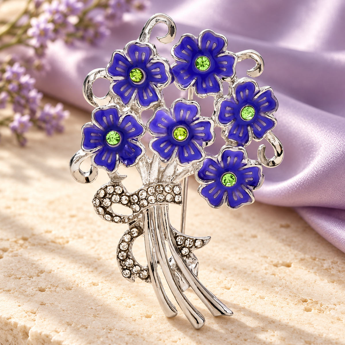 Enamel Flower Bouquet with Rhinestone Bow Brooch — styled background