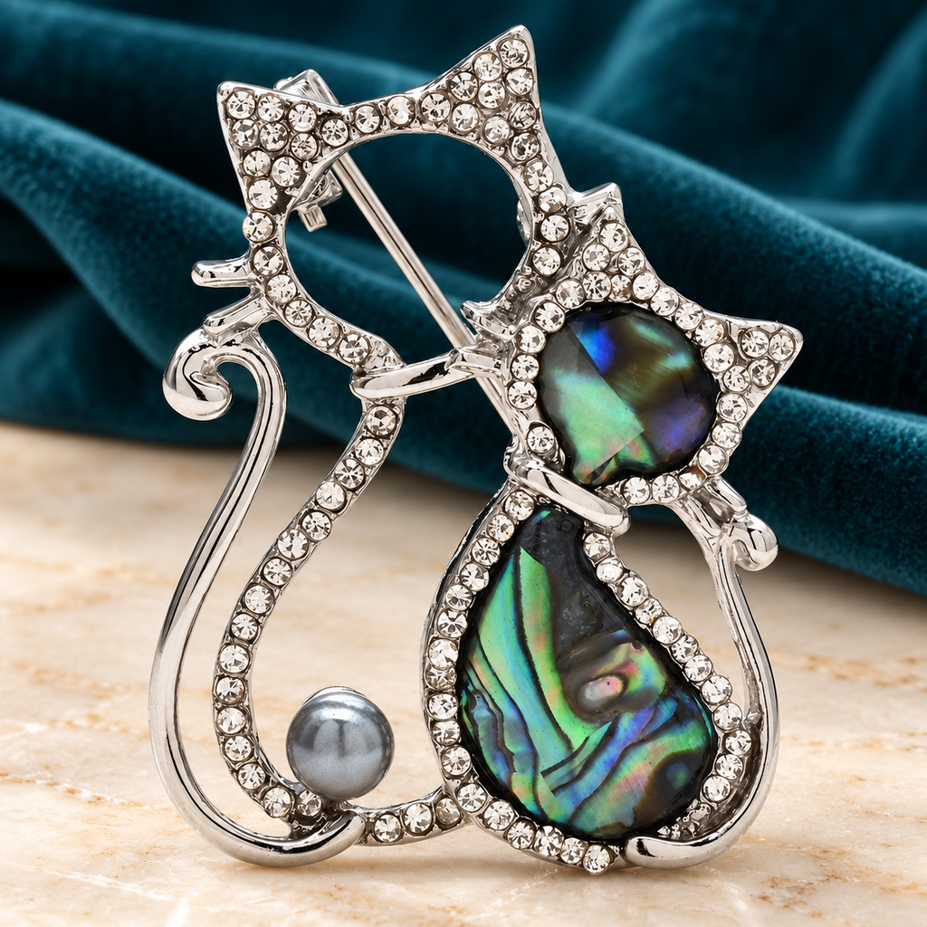 Rhinestone Cat Pair with Abalone-Look Insets Brooch — styled background