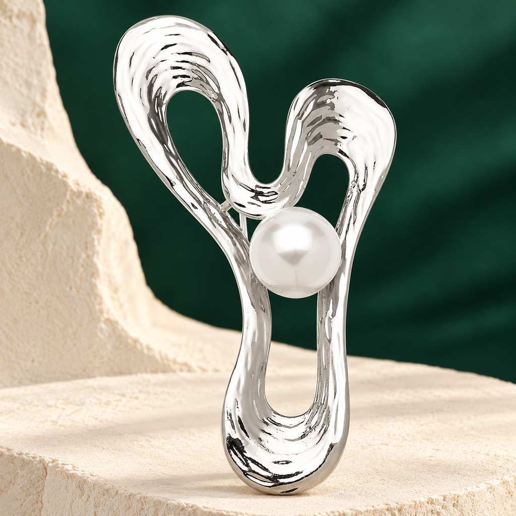 Sculptural Looped Ribbon with Pearl-Look Center Brooch — styled background