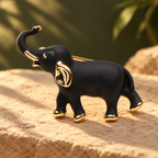 Black Enamel Raised Trunk Elephant Brooch — styled background