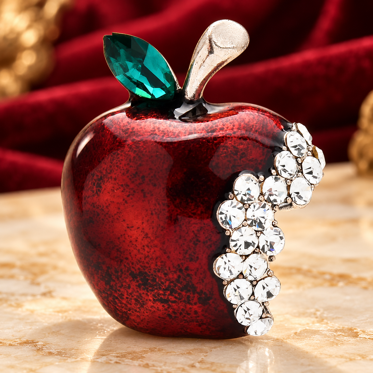 Red Enamel Jeweled Apple Brooch — styled background