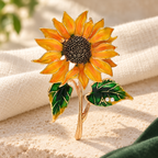 Enamel Sunflower with Leafy Stem Brooch — styled background