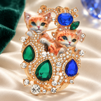 Ornate Jeweled Cat Pair Brooch — styled background