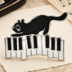 Enamel Cat on Piano Keys Brooch — styled background