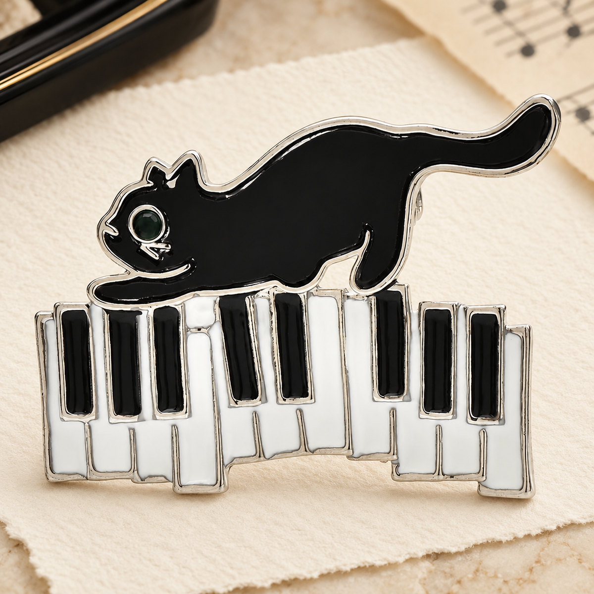 Enamel Cat on Piano Keys Brooch — styled background
