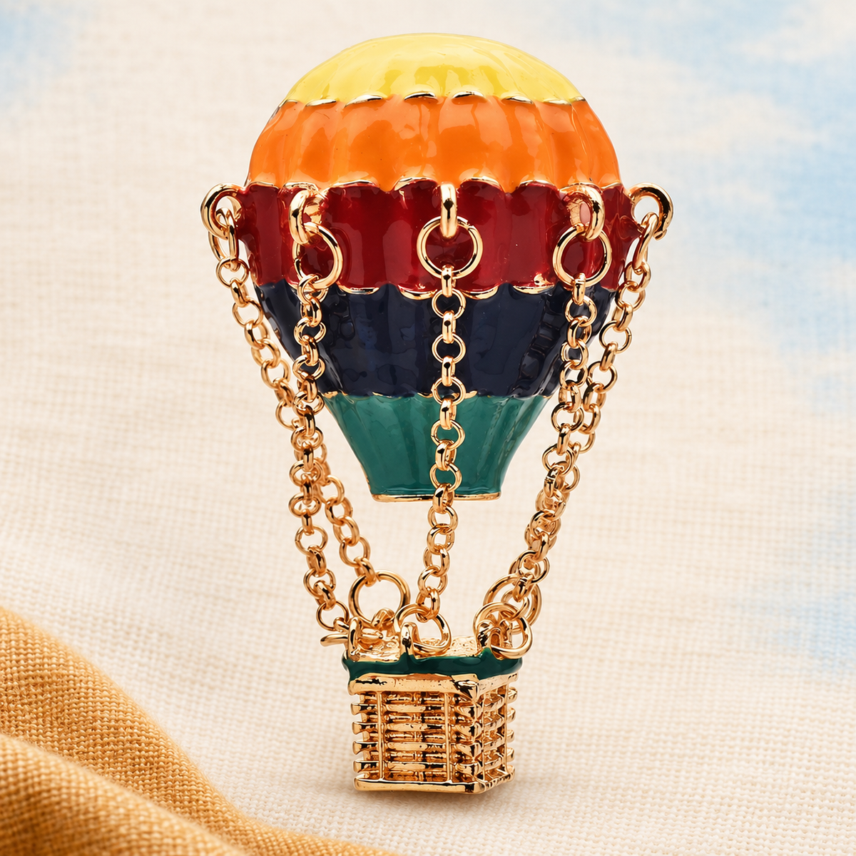 Rainbow Enamel Hot Air Balloon with Hanging Basket Brooch — styled background