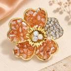 Textured Faceted Blossom with Rhinestone Petal Brooch — styled background