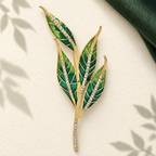Green Enamel Leaf Sprig with Rhinestone Stem Brooch — styled background