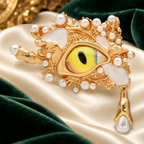 Surreal Yellow Eye with Pearl-Look and Teardrop Accents Brooch — styled background