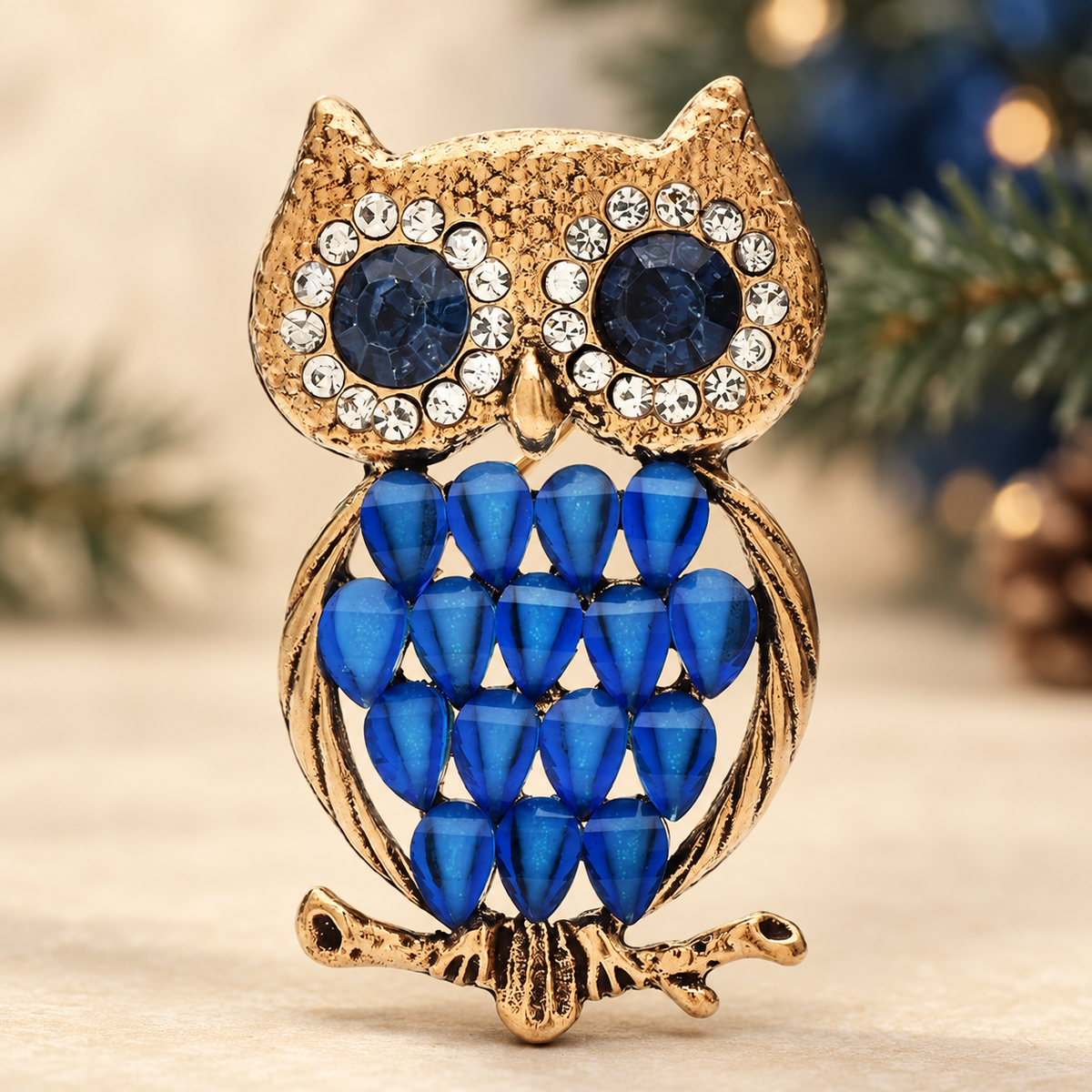 Vintage-Style Owl with Faceted Feather Body Brooch — styled background