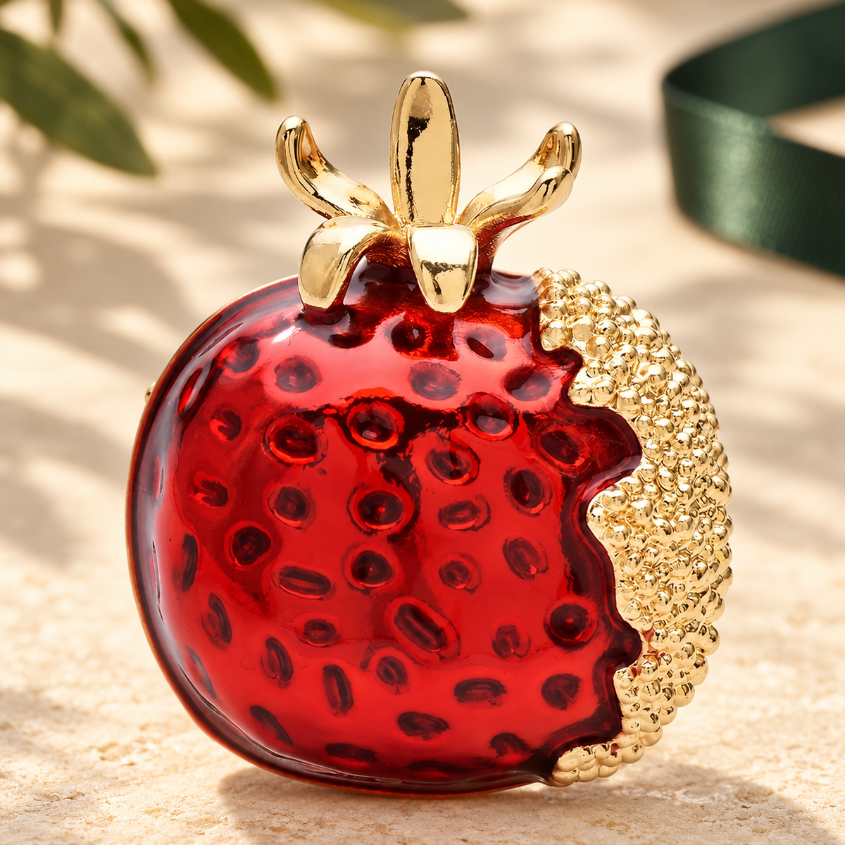 Red Enamel Pomegranate Brooch — styled background