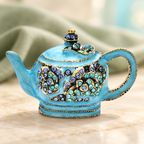 Ornate Enamel Teapot Brooch — styled background