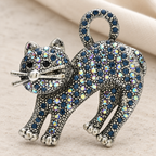 Arched-Back Rhinestone Cat Brooch — styled background