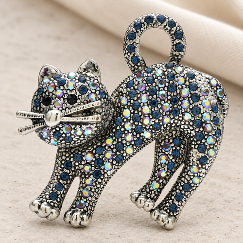 Arched-Back Rhinestone Cat Brooch — styled background