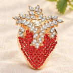 Rhinestone Strawberry with Jeweled Leaves Brooch — styled background