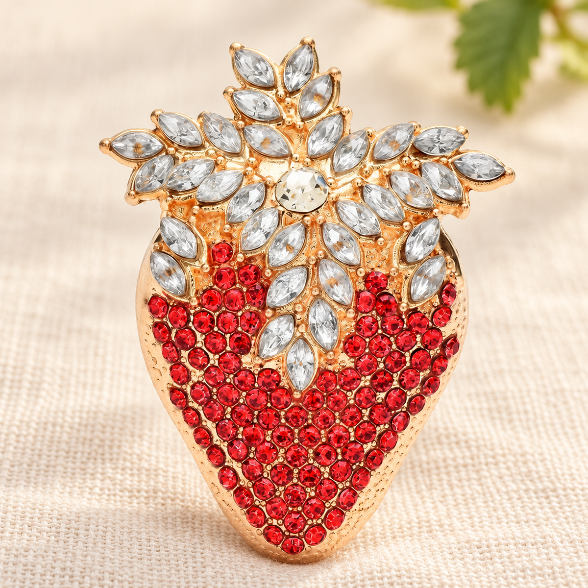 Rhinestone Strawberry with Jeweled Leaves Brooch — styled background